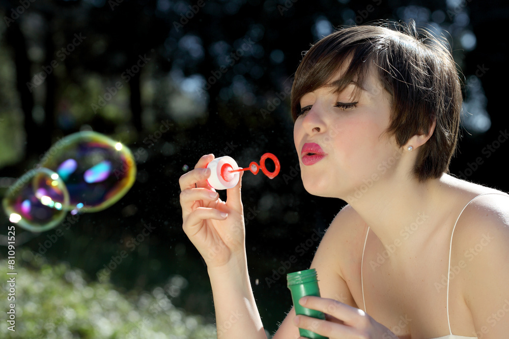 Woman blows soap bubbles