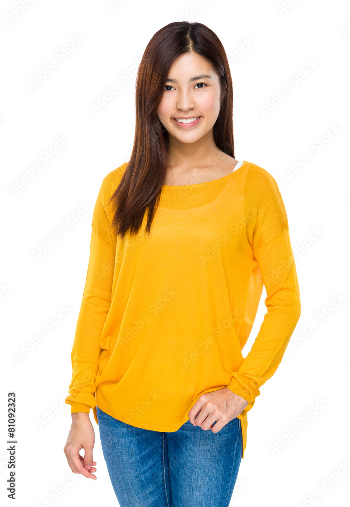 Fototapeta premium Smiling cool asian girl with hands in her jeans pocket