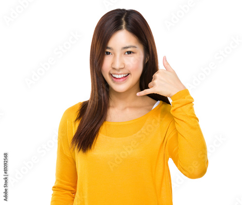 Woman showing call me phone hand sign smiling happy