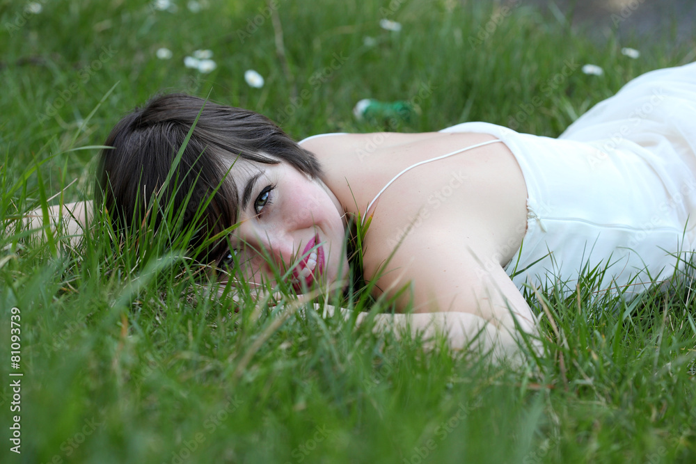 Smiling woman relaxing on the lawn Smiling woman relaxing on the lawn