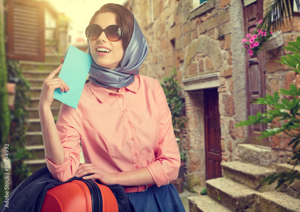 Elegant woman with a suitcase travel and ticket on street of ita Elegant woman with a suitcase travel and ticket on street of ita