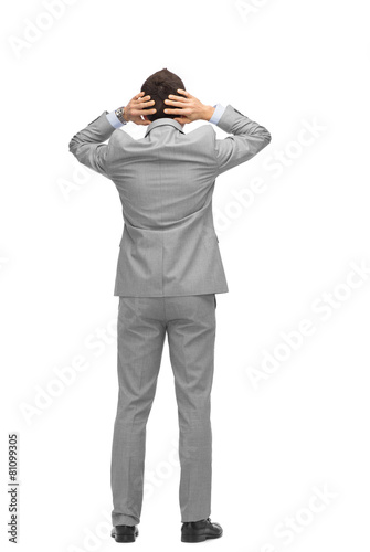 businessman grabs his head from back