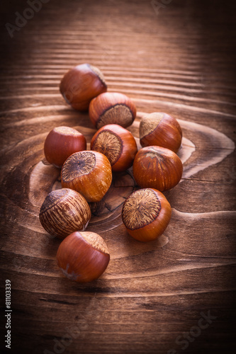 little heap of hazelnuts on vintage board food and drink concept