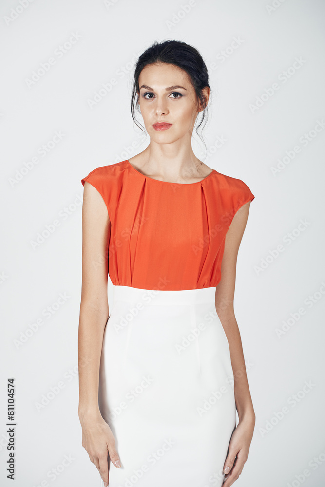 Fashion photo of young magnificent woman in a white and orange d Fashion photo of young magnificent woman in a white and orange d