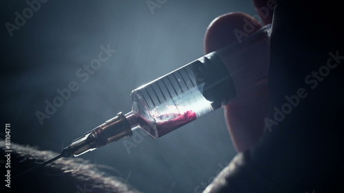 Junkie addict injects heroin or meth by syringe into a vein photo