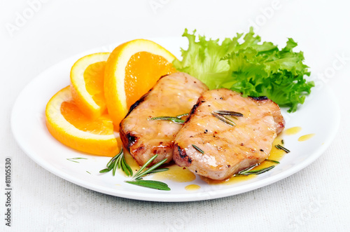 Pork chop with orange sauce and herbs
