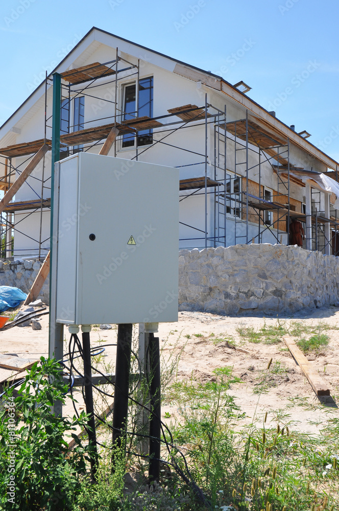 Naklejka premium Electric distribution box against home construction