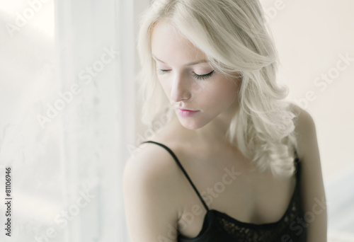 Portrait of a sexy blonde at home in the bedroom