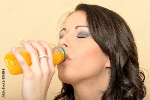 Attractive Beautiful Young Woman Holding a Bottle and Drinking F