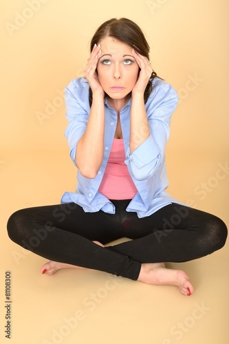 Young Crazy Woman Sitting on the Floor Wearing a Blue Shirt