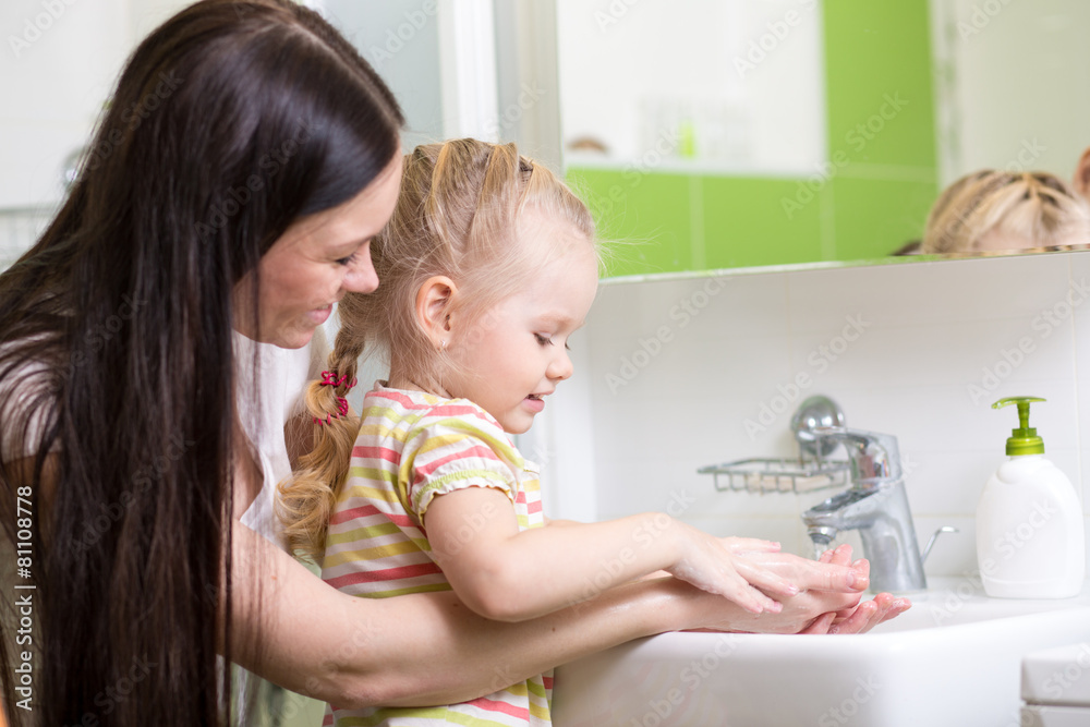 kid washing hands with soap in bathroom kid washing hands with soap in bathroom