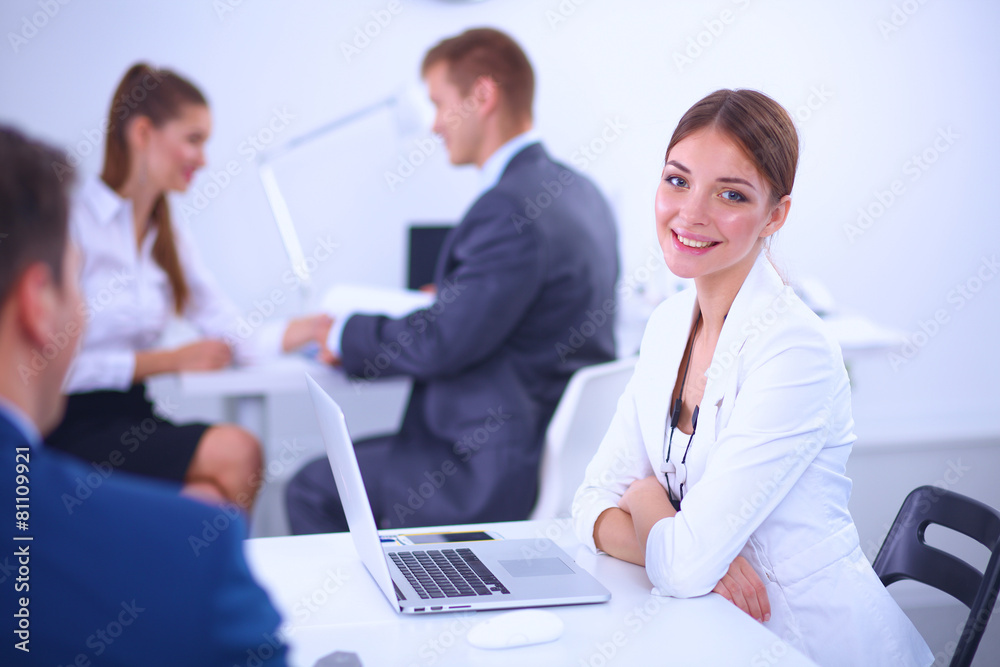 Beautiful young business people with colleagues discussing in Beautiful young business people with colleagues discussing in