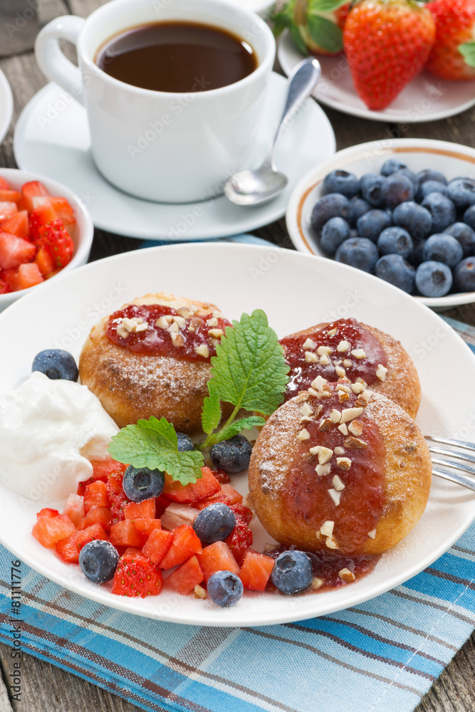 sweet cheese pancakes with berries and cream on a plate sweet cheese pancakes with berries and cream on a plate