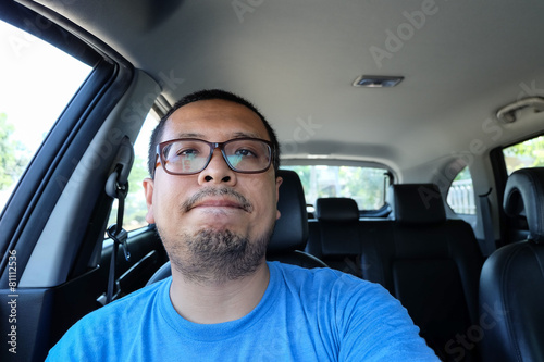 irritable man driving a car without seat belts