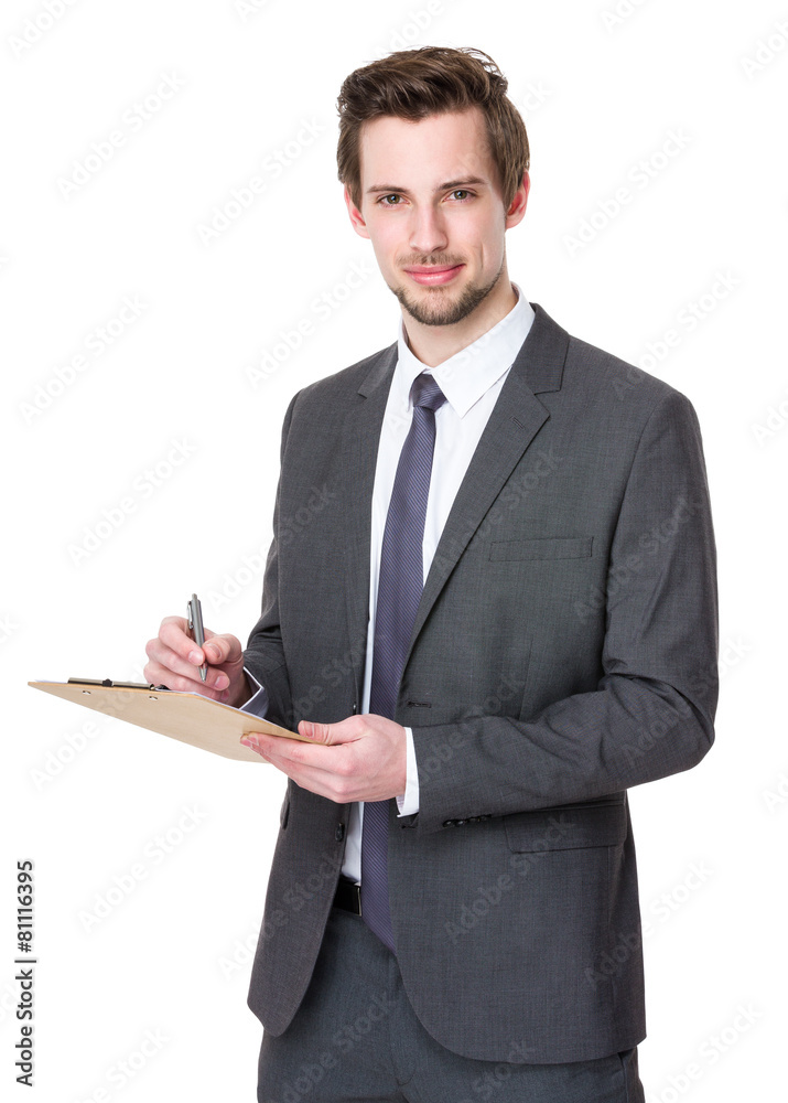 Businessman takes notes on clipboard Businessman takes notes on clipboard