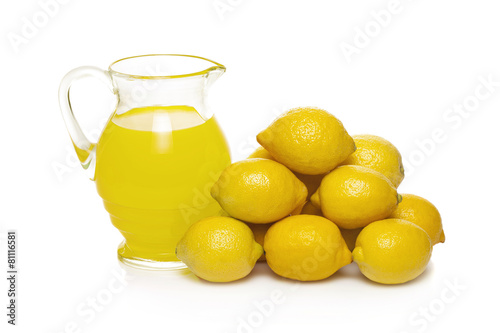 Lemon fruit juice in glass jug isolated on white