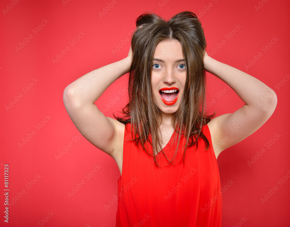 Beautiful surprised young woman over red background. Attractive Beautiful surprised young woman over red background. Attractive
