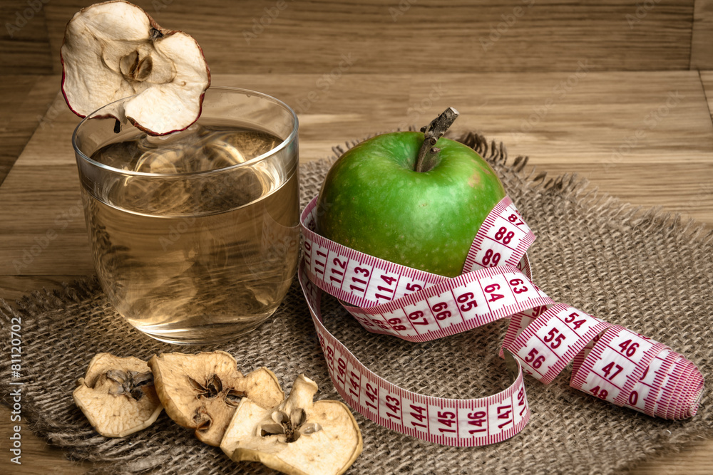 Apple juice with apples on wooden background