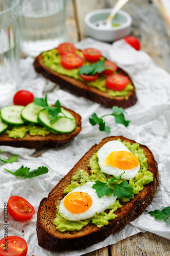 rye sandwiches and mashed avocado, eggs, tomatoes and cucumbers