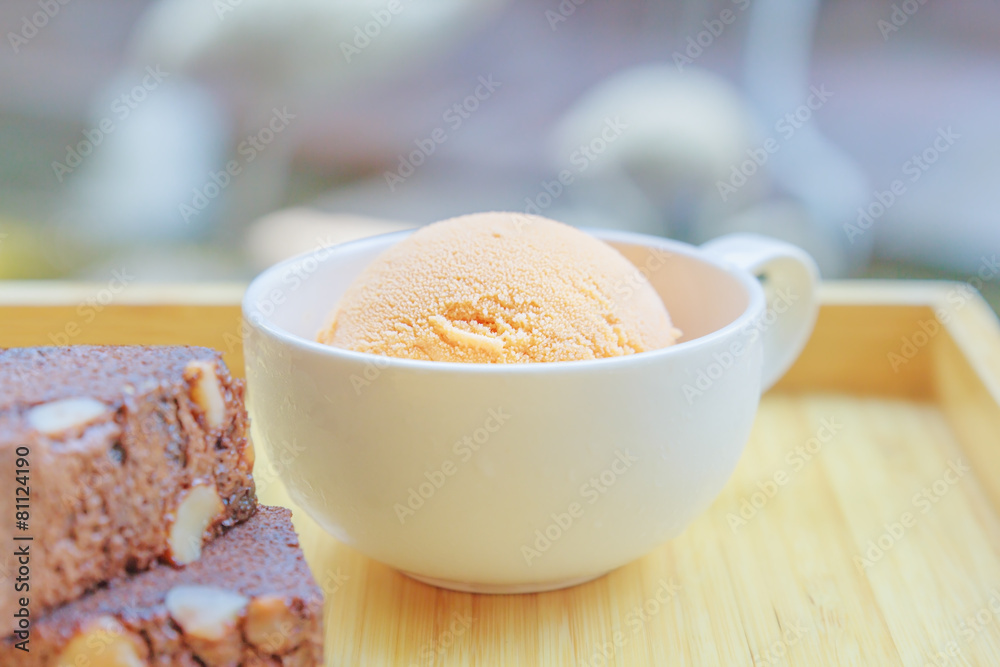 Ice cream in the cup with brownie on the wooden board Ice cream in the cup with brownie on the wooden board