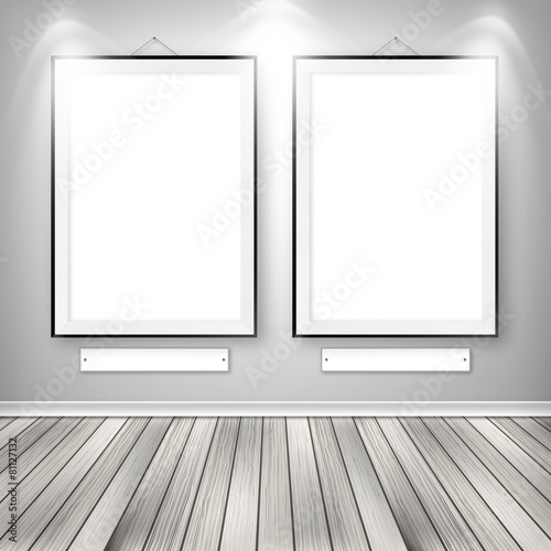 Gallery interior with two empty frames on wall