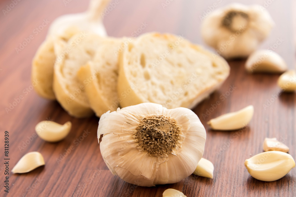 Fototapeta premium fresh baked loaf of bread with whole cloves of roasted garlic