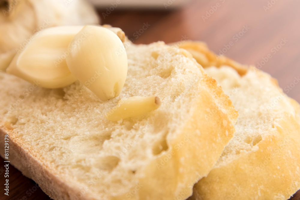 fresh baked loaf of bread with whole cloves of roasted garlic fresh baked loaf of bread with whole cloves of roasted garlic