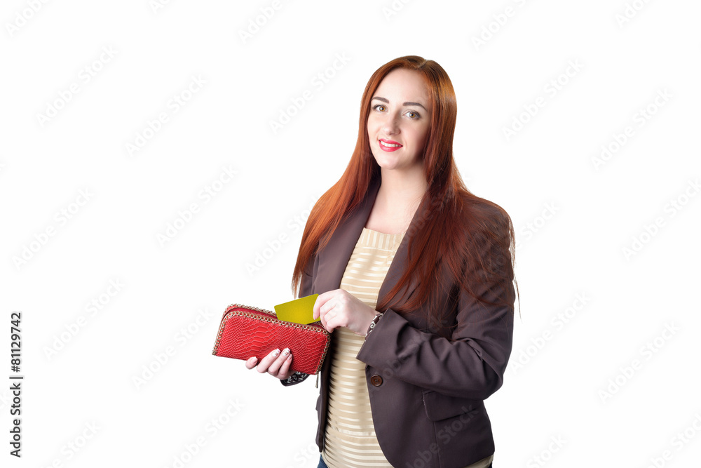 Redhead woman pulling credit card out of a red purse Redhead woman pulling credit card out of a red purse