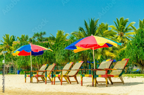 Amazing view of exotic sandy beach with sun umbrellas