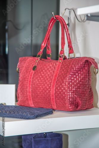 Red female bag on a shelf in the store