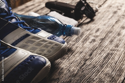 Running. Sport equipment. Sneakers, water, earphones and phone