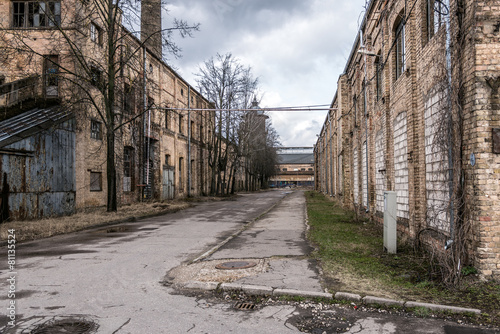 Old abandoned industrial street view with brick facades