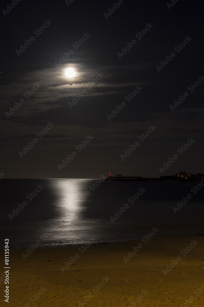 Fototapeta premium full moon over sandy beach