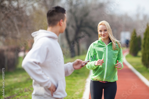 Young woman exercising with her coach 