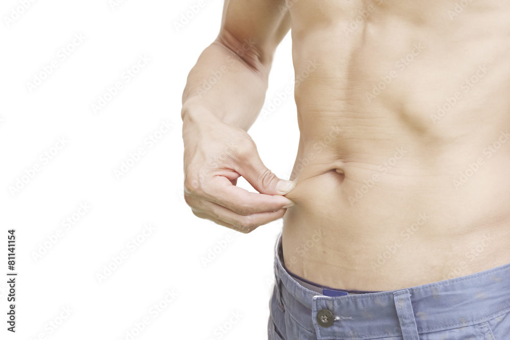 Fototapeta premium young man measuring fat on belly.