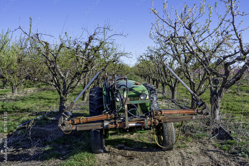 Tractor equipped with sprayers in an Idaho orchard Tractor equipped with sprayers in an Idaho orchard