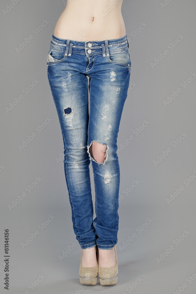 Body part, beautiful woman wearing jeans isolated on gray backgr Body part, beautiful woman wearing jeans isolated on gray backgr