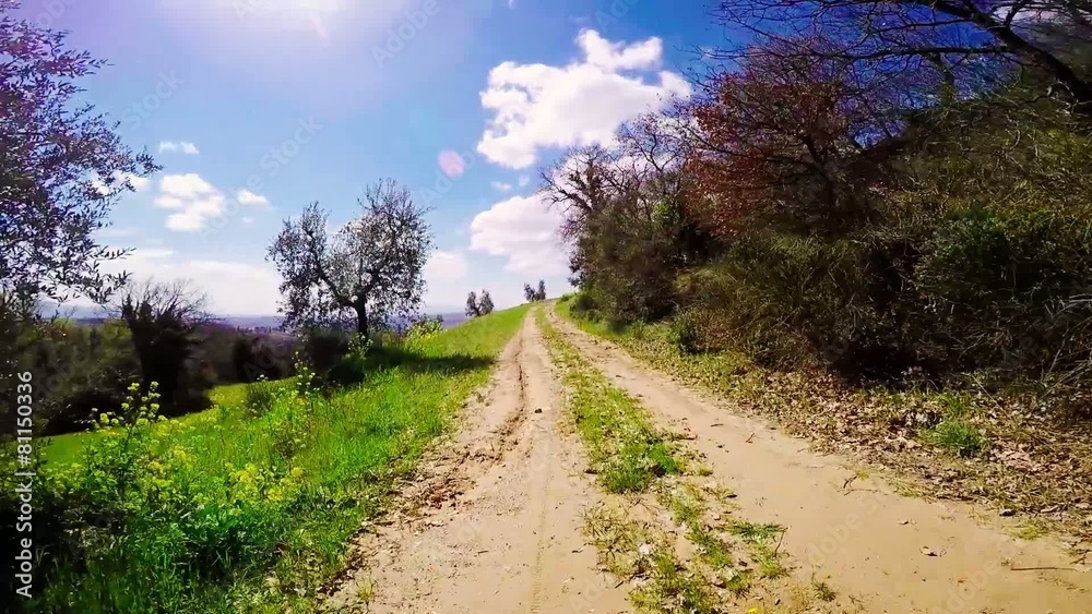riding on mountain bike in a tuscany contryside, frontal view riding on mountain bike in a tuscany contryside, frontal view