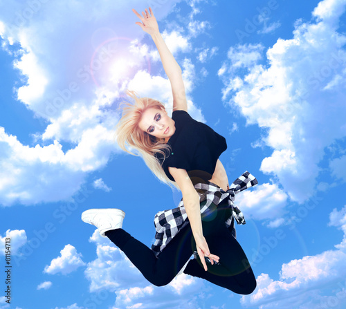 Jumping woman on sky backgr...