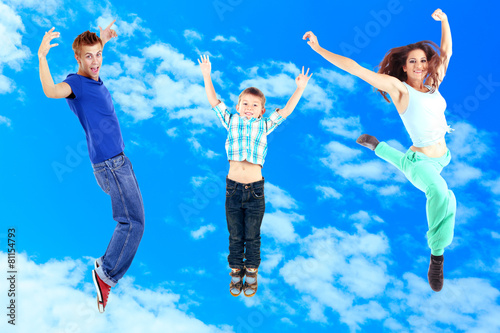 Jumping people on sky backg...
