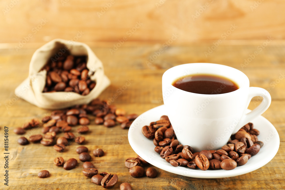 Cup of coffee with beans on rustic wooden background Cup of coffee with beans on rustic wooden background