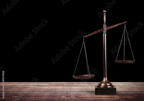 Lawyer. Law scales on table in front black background. Symbol of