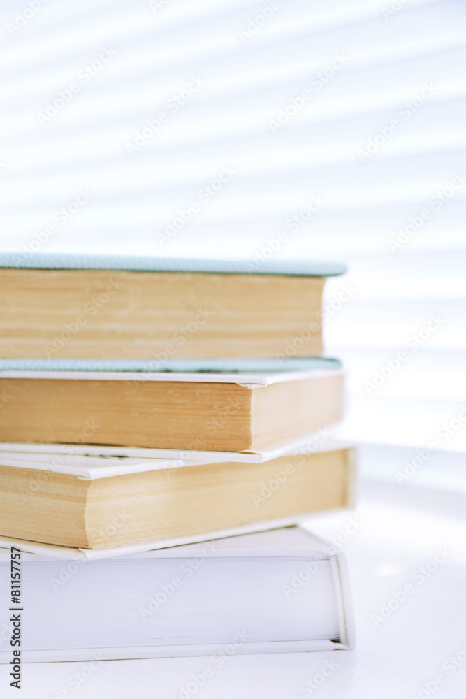 Books on white windowsill, close up Books on white windowsill, close up