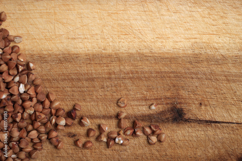 Grains of buckwheat on the wooden board