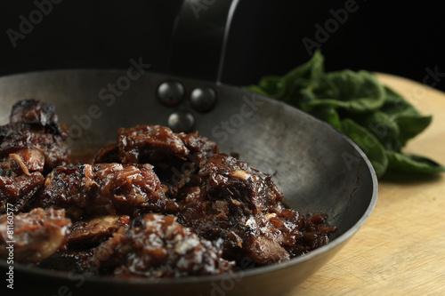 Pork ribs with honey-soy sauce in the frying pan
