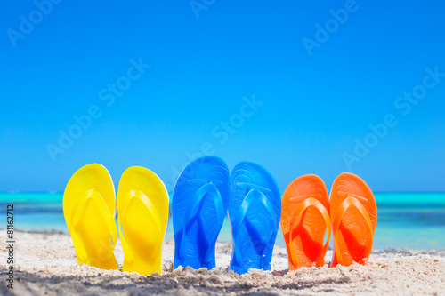 Colorful beach flip flops sandals on the beach