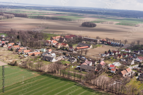 aerial view of spring time village harvest fields landscape © mariusz szczygieł