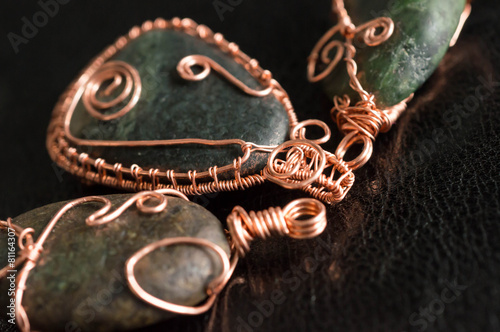 Some wire wrapped pendants against a dark background