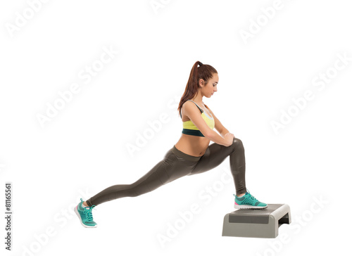 Fototapeta Naklejka Na Ścianę i Meble -  Beautiful athletic girl exercising on stepper