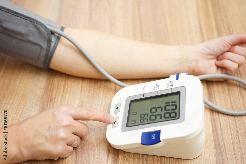 Woman is checking blood pressure at home Woman is checking blood pressure at home